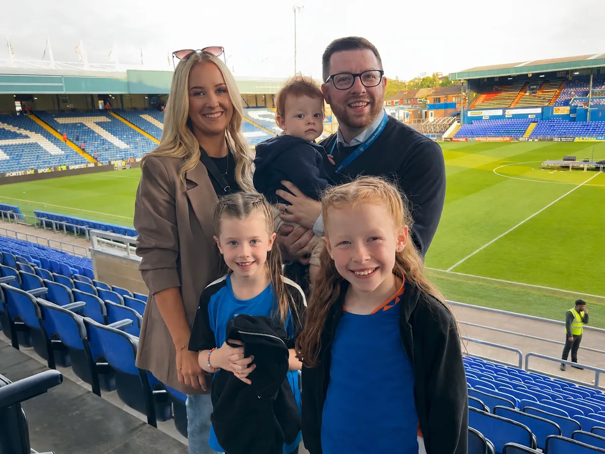 Dale with his wife and their three children at a football ground